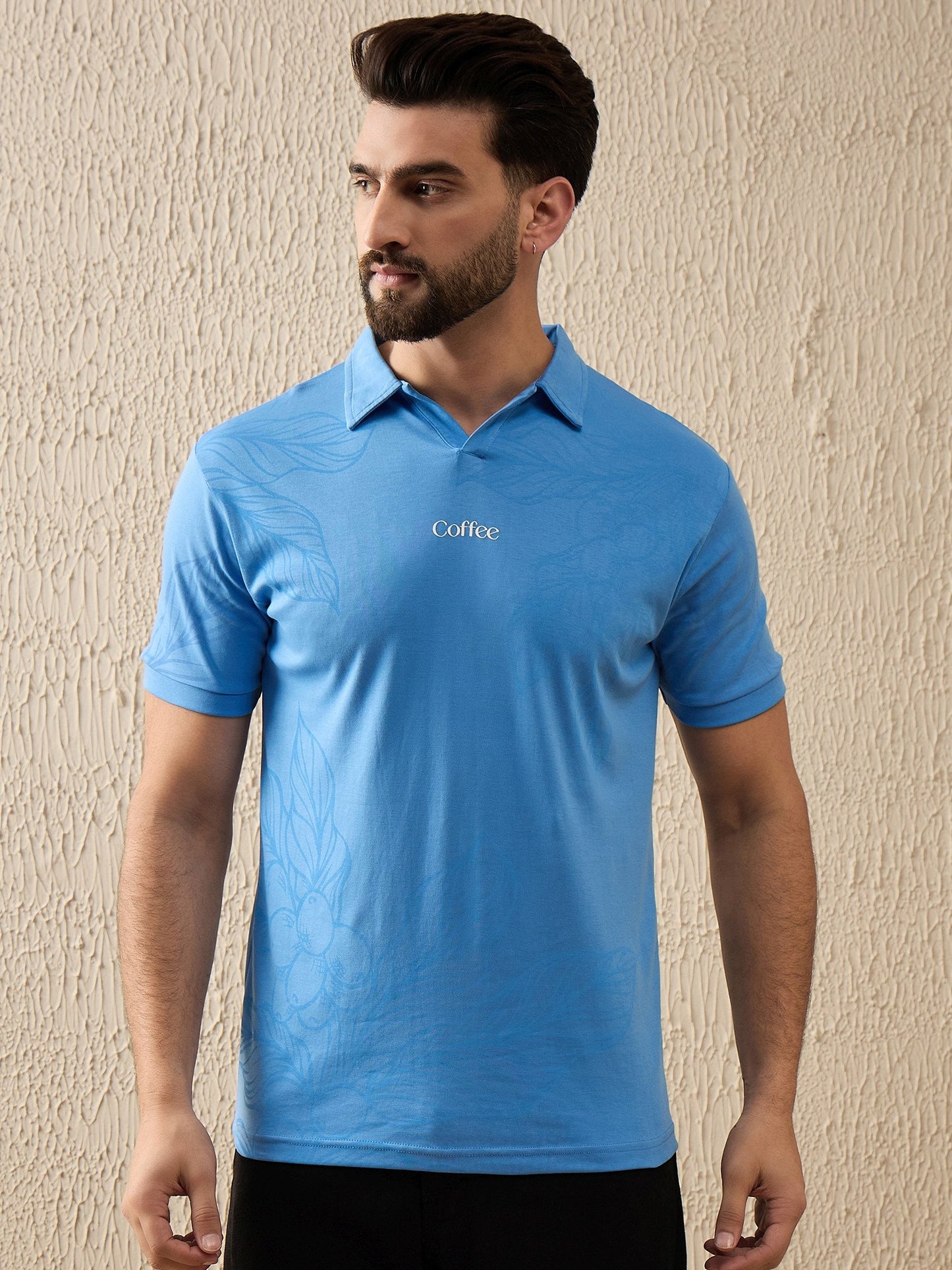 Blue botanical brew polo shirt featuring minimal coffee plant motif