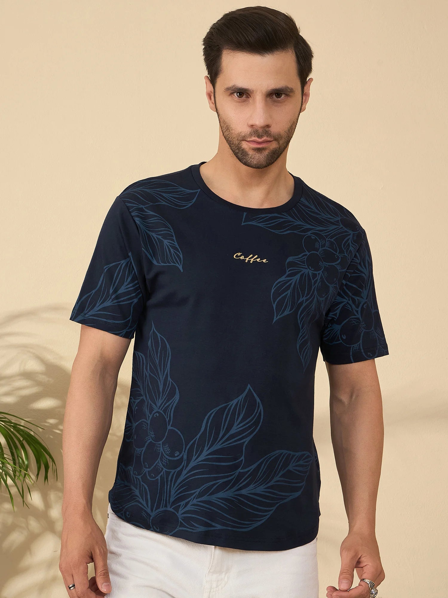 Navy blue t-shirt featuring elegant botanical coffee plant artwork